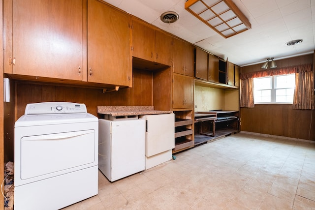 laundry area featuring independent washer and dryer, visible vents, laundry area, and light floors
