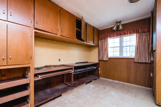 miscellaneous room with wooden walls and light floors