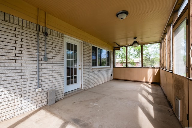unfurnished sunroom with a ceiling fan