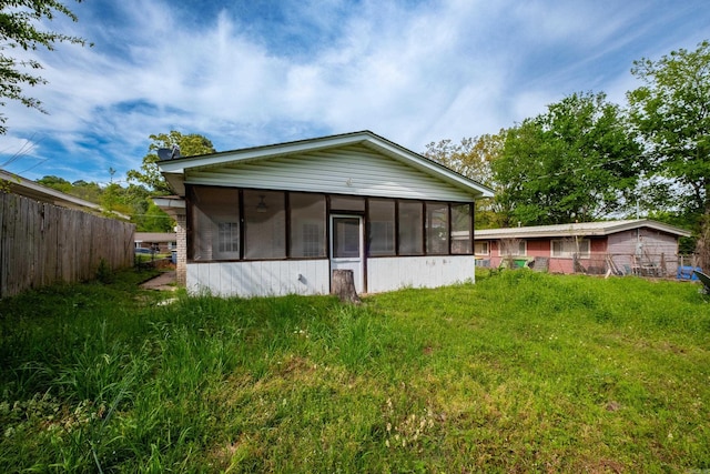 back of house with a sunroom and fence