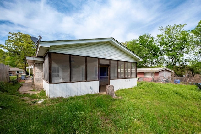 back of house with a sunroom and fence
