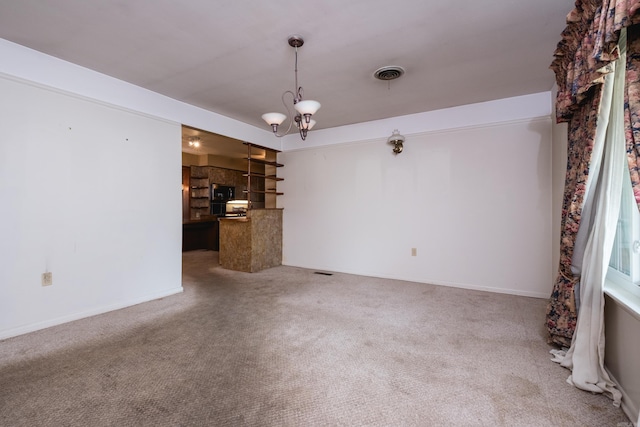 spare room featuring carpet flooring, visible vents, and baseboards