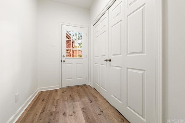 entryway featuring light wood-style flooring and baseboards