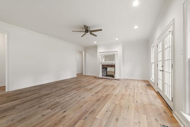 unfurnished living room with ceiling fan, light wood finished floors, recessed lighting, baseboards, and ornamental molding