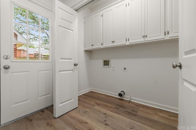 washroom with washer hookup, baseboards, wood finished floors, cabinet space, and hookup for an electric dryer