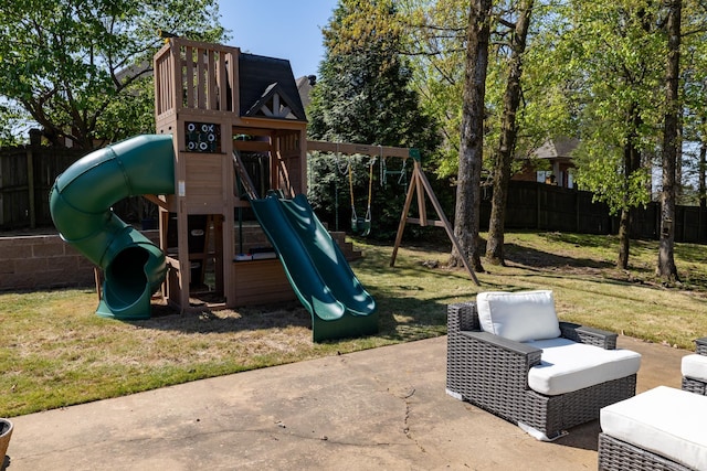 view of jungle gym featuring a patio, a yard, and a fenced backyard