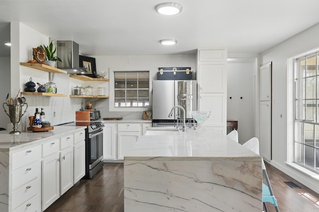 kitchen featuring open shelves, stainless steel range with electric cooktop, dark wood finished floors, fridge, and a sink