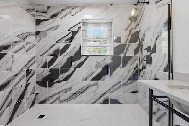 full bath with a tile shower