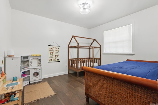 bedroom featuring dark wood-style flooring and baseboards