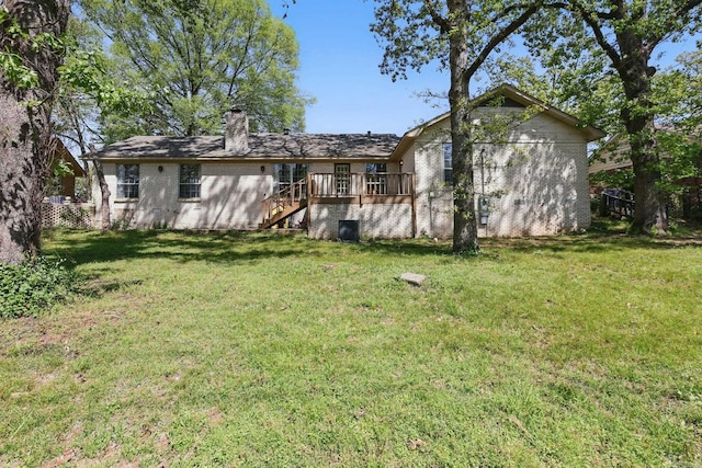 rear view of property with a yard, stairway, and a chimney