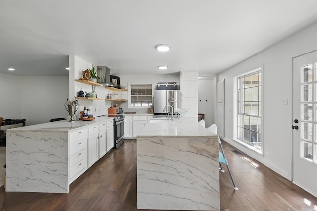 kitchen with refrigerator, stainless steel electric range, open shelves, dark wood-type flooring, and a sink