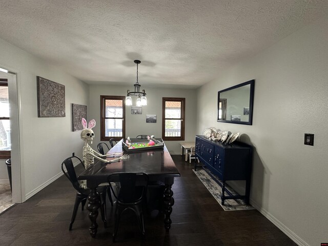 dining area featuring a textured ceiling, baseboards, and dark wood finished floors