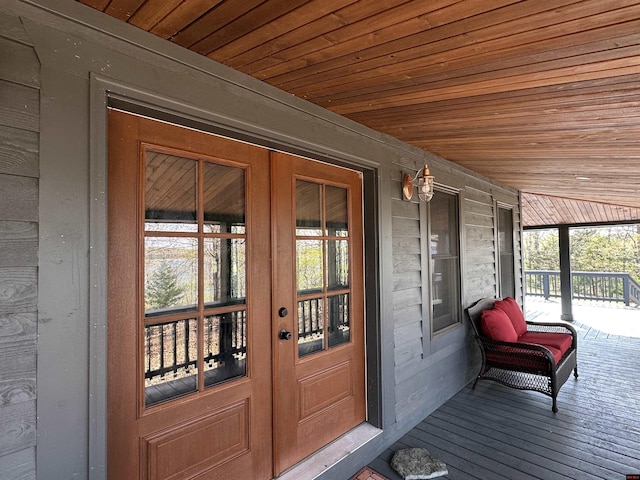 property entrance featuring french doors and a porch