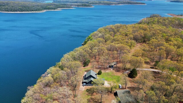 birds eye view of property featuring a wooded view and a water view