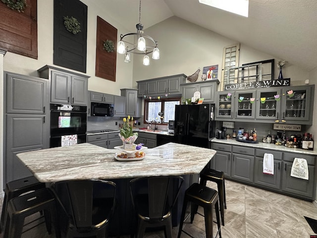 kitchen with tasteful backsplash, gray cabinets, glass insert cabinets, high vaulted ceiling, and black appliances