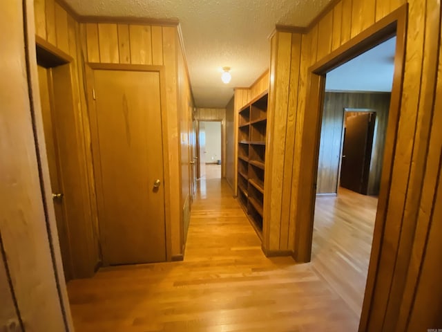 817 Waco St, Camden, AR 71701 - hall with wooden walls, a textured ceiling, light wood-style flooring, and crown molding