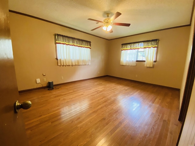 817 Waco St, Camden, AR 71701 - empty room with crown molding, wood finished floors, ceiling fan, a textured ceiling, and baseboards