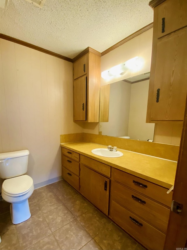 817 Waco St, Camden, AR 71701 - half bathroom featuring ornamental molding, vanity, toilet, a textured ceiling, and tile patterned flooring