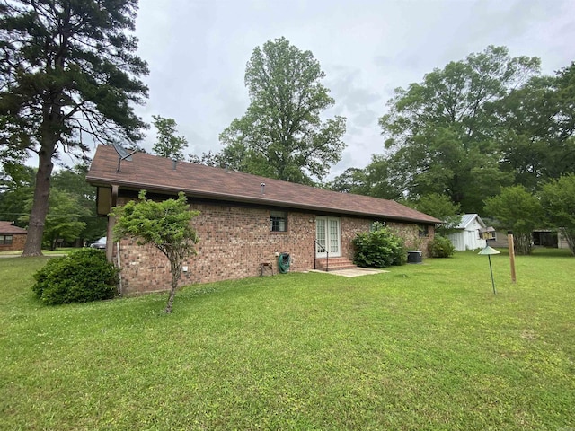 817 Waco St, Camden, AR 71701 - back of property with a yard, entry steps, brick siding, and cooling unit