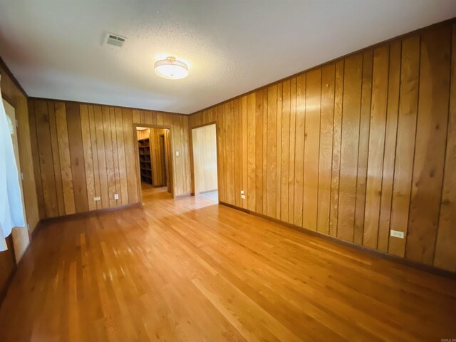 817 Waco St, Camden, AR 71701 - spare room with wood finished floors, wooden walls, and baseboards