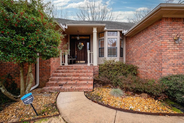 doorway to property with brick siding