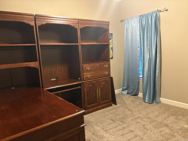 unfurnished office with carpet flooring and baseboards