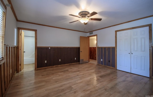 1295 Polk Road 47, Mena, AR 71953 - unfurnished bedroom featuring visible vents, light wood-type flooring, a ceiling fan, crown molding, and a wainscoted wall