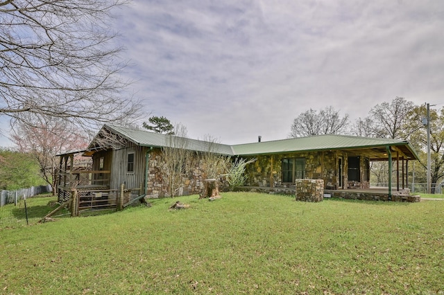 1295 Polk Road 47, Mena, AR 71953 - back of house with metal roof, stone siding, and a lawn