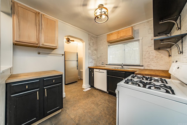 kitchen featuring open shelves, white appliances, dark cabinetry, and wooden counters