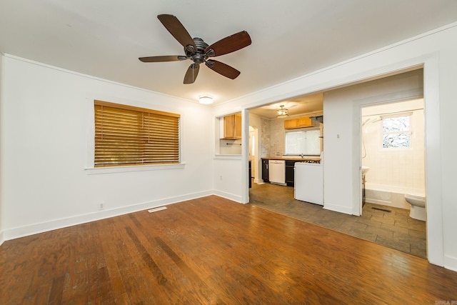 unfurnished living room with dark wood-style flooring, baseboards, and a ceiling fan