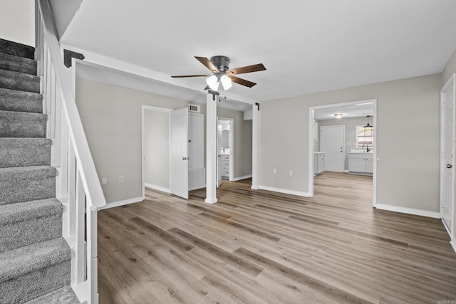 1216 Wade Ave, Judsonia, AR 72081 - unfurnished living room featuring stairs, light wood-style floors, visible vents, and ceiling fan