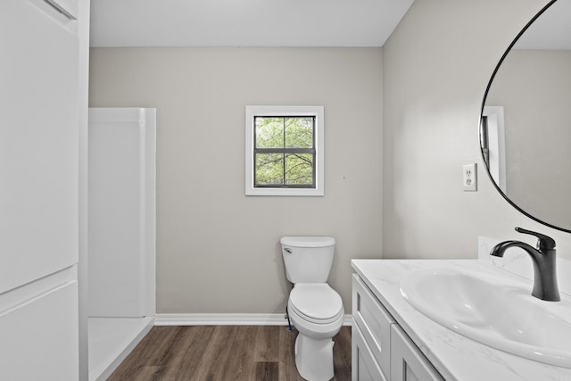 1216 Wade Ave, Judsonia, AR 72081 - bathroom with toilet, wood finished floors, vanity, and baseboards