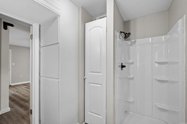 1216 Wade Ave, Judsonia, AR 72081 - bathroom with a shower, baseboards, and wood finished floors