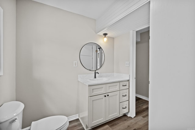 1216 Wade Ave, Judsonia, AR 72081 - half bath with vanity, baseboards, toilet, and wood finished floors