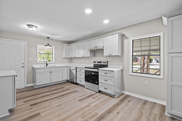 1216 Wade Ave, Judsonia, AR 72081 - kitchen featuring baseboards, a sink, light countertops, light wood-type flooring, and stainless steel electric range