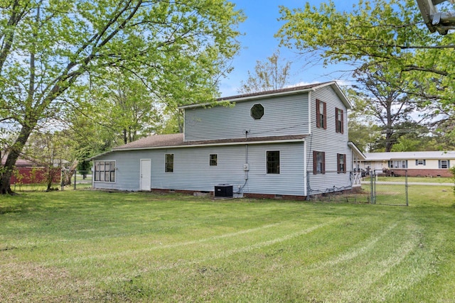 1216 Wade Ave, Judsonia, AR 72081 - rear view of house with central AC, crawl space, a yard, fence, and a gate