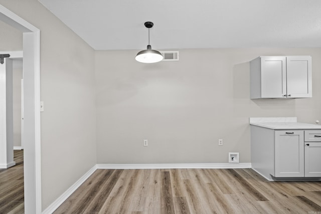 1216 Wade Ave, Judsonia, AR 72081 - unfurnished dining area featuring visible vents, baseboards, and light wood-style floors