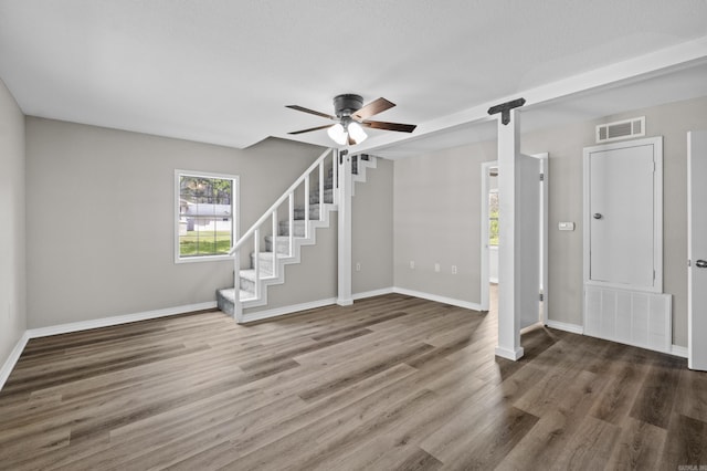 1216 Wade Ave, Judsonia, AR 72081 - below grade area with a barn door, visible vents, wood finished floors, and ceiling fan