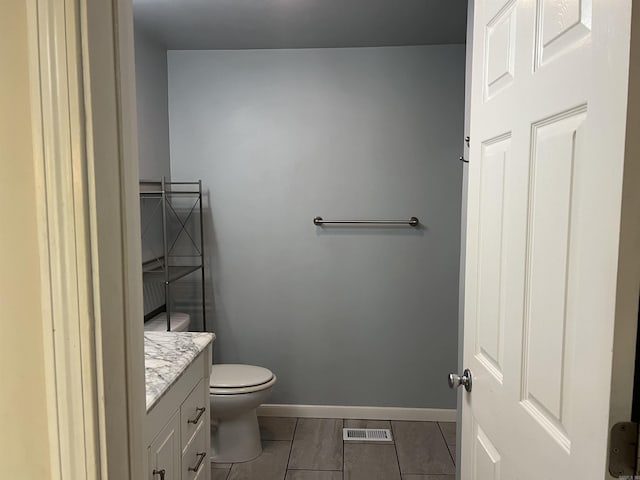 5301 Owensville Cutoff, Lonsdale, AR 72087 - bathroom featuring vanity, visible vents, toilet, tile patterned floors, and baseboards