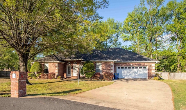 ranch-style house featuring concrete driveway, fence, a front lawn, and brick siding