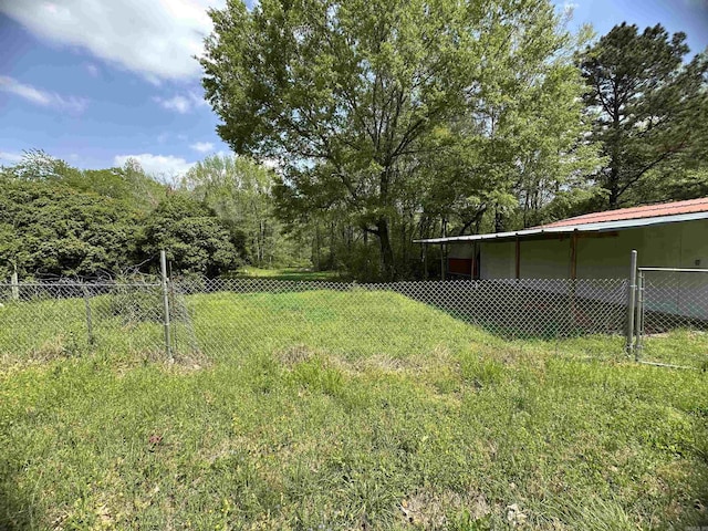 view of yard with fence and a pole building