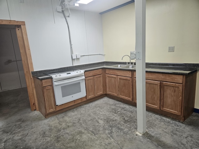 kitchen with brown cabinetry, white electric range, a sink, and dark countertops