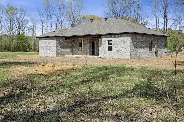 back of house with brick siding