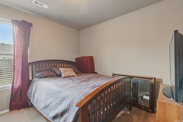 bedroom featuring carpet, visible vents, and baseboards