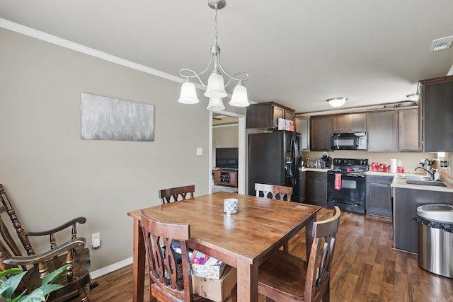 dining room with ornamental molding, visible vents, baseboards, a notable chandelier, and dark wood-style floors