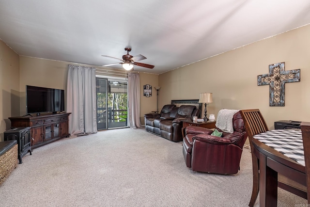 living room featuring ceiling fan and carpet