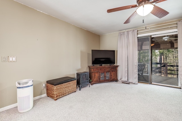 living area featuring ceiling fan, carpet flooring, and baseboards