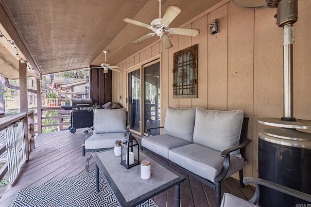 deck featuring grilling area, an outdoor living space, and ceiling fan