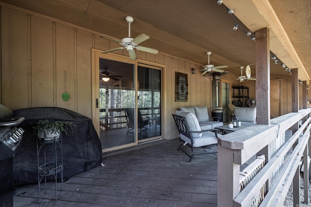 deck featuring area for grilling and a ceiling fan