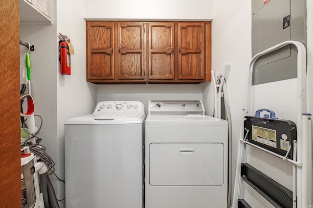 laundry room featuring separate washer and dryer and cabinet space